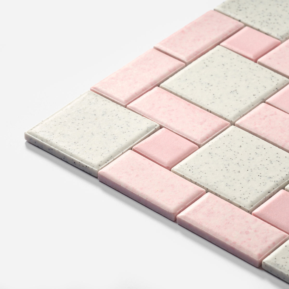 Pink and speckled white square mosaic tiles arranged in a staggered pattern on a clean white background.